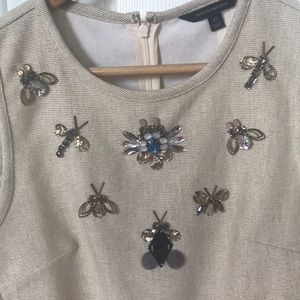 Off-white cotton shell with gemstone insects.